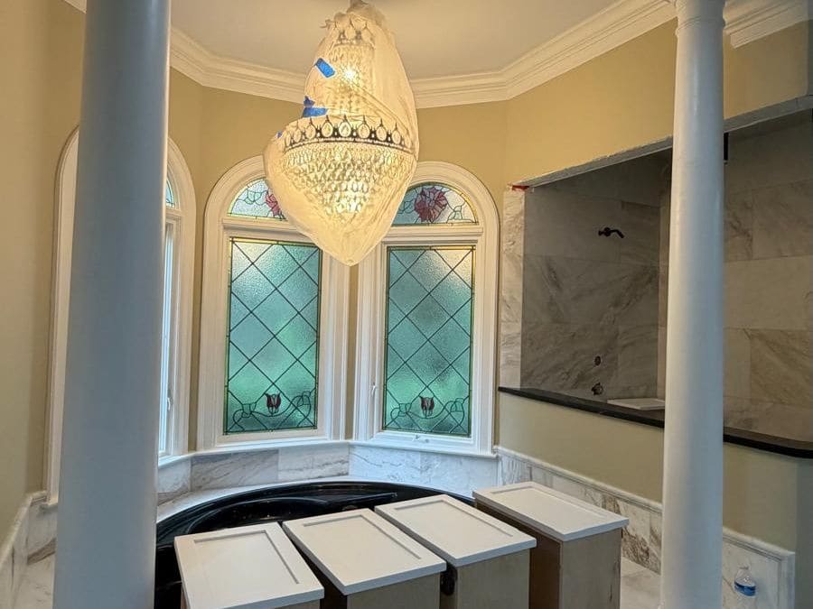 Master bathroom remodel in progress with marble surfaces and new vanity cabinets